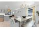 Bright dining room with modern chandelier, neutral decor, and an adjacent kitchen with stainless steel appliances at 13227 Spring Grove Way, Winter Garden, FL 34787