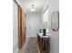 Stylish entryway featuring a sliding barn door, decorative table, and modern decor at 13227 Spring Grove Way, Winter Garden, FL 34787