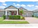 Charming two-story home with a well-manicured lawn, beautiful landscaping, and a cozy front porch at 13227 Spring Grove Way, Winter Garden, FL 34787