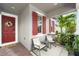 Cozy front porch featuring outdoor seating, a decorative wreath on the door, and brick flooring at 13227 Spring Grove Way, Winter Garden, FL 34787