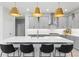 Contemporary kitchen featuring gray cabinetry, stainless steel range hood, white countertops, island with sink and seating at 13227 Spring Grove Way, Winter Garden, FL 34787