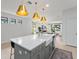 Open-concept kitchen with a large island, pendant lighting, and views into the adjacent living spaces at 13227 Spring Grove Way, Winter Garden, FL 34787