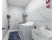 Functional laundry room with washer, dryer, utility sink, and wire shelving for storage at 13227 Spring Grove Way, Winter Garden, FL 34787