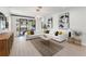Inviting living room with stylish decor, large sectional, coffee table, and access to outdoor living space at 13227 Spring Grove Way, Winter Garden, FL 34787