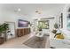 Bright living room with modern decor, large sectional sofa, media console, and access to outdoor space at 13227 Spring Grove Way, Winter Garden, FL 34787