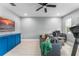 Comfortable living room featuring a gray sofa, bright blue entertainment center, and neutral walls at 13227 Spring Grove Way, Winter Garden, FL 34787