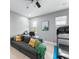 Cozy living space with a sofa, workstation, treadmill and natural light from the window at 13227 Spring Grove Way, Winter Garden, FL 34787