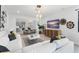 Well-lit living room showcasing modern decor, stylish furniture, and an open layout to the adjacent dining area at 13227 Spring Grove Way, Winter Garden, FL 34787