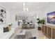 Inviting living room with contemporary furnishings, decorative lighting, and an open floor plan to the kitchen at 13227 Spring Grove Way, Winter Garden, FL 34787