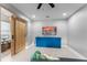 Modern living room with sleek hardwood floors, a sliding barn door, and a contemporary entertainment center at 13227 Spring Grove Way, Winter Garden, FL 34787