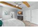 Comfortable main bedroom featuring wooden beams, ceiling fan, ensuite bathroom, and ample space at 13227 Spring Grove Way, Winter Garden, FL 34787