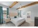 Serene main bedroom with exposed wood beams, neutral tones, and ensuite bathroom access at 13227 Spring Grove Way, Winter Garden, FL 34787