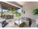 Outdoor living space with stylish furniture, modern bar area, and view of the backyard at 13227 Spring Grove Way, Winter Garden, FL 34787