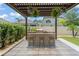 Backyard patio with an outdoor kitchen, bar seating, and a lush garden view at 13227 Spring Grove Way, Winter Garden, FL 34787