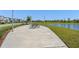 Park featuring picnic tables, a concrete path, and a scenic pond view at 13227 Spring Grove Way, Winter Garden, FL 34787