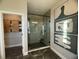 Modern bathroom featuring a glass-enclosed shower with hexagon tile and decorative wall art at 1341 Lumpini St, St Cloud, FL 34771