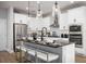 Stylish kitchen with stainless steel appliances, a large island, and modern pendant lighting at 1341 Lumpini St, St Cloud, FL 34771