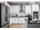 Well-designed kitchen with white cabinetry, a geometric backsplash, and stainless steel appliances at 1341 Lumpini St, St Cloud, FL 34771