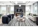 Elegant living room featuring a modern decor, coffered ceilings, and large windows at 1341 Lumpini St, St Cloud, FL 34771