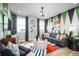 Vibrant living room featuring modern furniture, colorful art, and ample natural light at 1341 Lumpini St, St Cloud, FL 34771