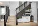 Elegant staircase features wooden steps, iron railings, and a built-in bar with a beverage fridge at 1341 Lumpini St, St Cloud, FL 34771