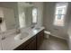 This bathroom features a double vanity, white tile walls, and wood-look floors at 1354 Twelve Oaks Rd, St Cloud, FL 34771
