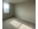 This bedroom boasts a single window, neutral-toned walls, and cozy carpet flooring at 1354 Twelve Oaks Rd, St Cloud, FL 34771