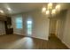 Dining area with wood floors, chandelier, and sliding glass doors leading to the backyard at 1354 Twelve Oaks Rd, St Cloud, FL 34771