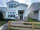 Charming two-story home featuring a welcoming front porch with stone accents and a well-manicured lawn at 1354 Twelve Oaks Rd, St Cloud, FL 34771