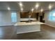 Modern kitchen with stainless steel appliances, an island with sink, and dark wood cabinets at 1354 Twelve Oaks Rd, St Cloud, FL 34771