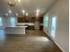 Bright kitchen boasts a large island, stainless appliances, and easy access to outdoor patio at 1354 Twelve Oaks Rd, St Cloud, FL 34771