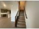 Staircase featuring wood treads, a dark wood handrail, and access to the upper level at 1354 Twelve Oaks Rd, St Cloud, FL 34771