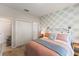 Well-lit bedroom with patterned wallpaper, comfortable bed, and ample closet space at 1382 Foltz Loop, Oakland, FL 34787