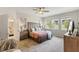 Bright bedroom with large windows, neutral tones, and a stylish ceiling fan at 1382 Foltz Loop, Oakland, FL 34787