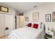 Comfortable bedroom with a white frame bed, soft bedding, and thoughtfully arranged wall art at 1382 Foltz Loop, Oakland, FL 34787