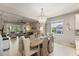 Spacious dining area flows into living space, featuring natural light and stylish chandelier at 1382 Foltz Loop, Oakland, FL 34787