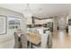Bright dining area featuring a chandelier, light wood floors, and direct view of the modern kitchen at 1382 Foltz Loop, Oakland, FL 34787
