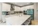 Modern kitchen with white cabinetry, stainless steel appliances, and a large kitchen island with seating at 1382 Foltz Loop, Oakland, FL 34787