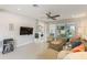 Modern living room flows to outdoor screened patio, featuring entertainment area and bright natural light at 1382 Foltz Loop, Oakland, FL 34787