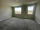 Bright bedroom featuring plush carpet, natural light from large windows, and a peaceful atmosphere at 1411 Mount Royal Dr, St Cloud, FL 34771