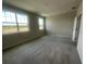 Inviting bedroom featuring plush carpet, natural light from large windows, and a serene atmosphere at 1411 Mount Royal Dr, St Cloud, FL 34771