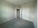 Comfortable bedroom featuring plush carpet, a spacious closet, and a view of the adjacent room at 1411 Mount Royal Dr, St Cloud, FL 34771