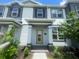 Close up of the Townhouse entry featuring a light-filled doorway and well-kept landscaping, offering an inviting entrance at 1411 Mount Royal Dr, St Cloud, FL 34771