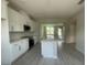 Modern kitchen featuring white cabinets, an island with countertop seating and stainless steel appliances at 1411 Mount Royal Dr, St Cloud, FL 34771