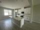 Well-lit kitchen featuring white cabinets, stainless steel appliances, and a center island perfect for entertaining at 1411 Mount Royal Dr, St Cloud, FL 34771