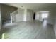 Open floor plan showcases tile flooring, flowing into the modern kitchen and staircase to the upper level at 1411 Mount Royal Dr, St Cloud, FL 34771