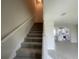 View of the staircase leading to the upper level, complemented by an open-concept layout at 1411 Mount Royal Dr, St Cloud, FL 34771