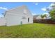 Well-manicured backyard with a full lawn and an exterior view of the home's back-side at 1413 Brookebridge Dr, Orlando, FL 32825