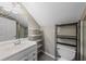 Bathroom featuring white cabinetry, gray tile floors, storage shelving and updated fixtures at 1413 Brookebridge Dr, Orlando, FL 32825