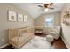 Charming Bedroom with crib, glider, and neutral decor, creating a soothing and inviting space at 1413 Brookebridge Dr, Orlando, FL 32825